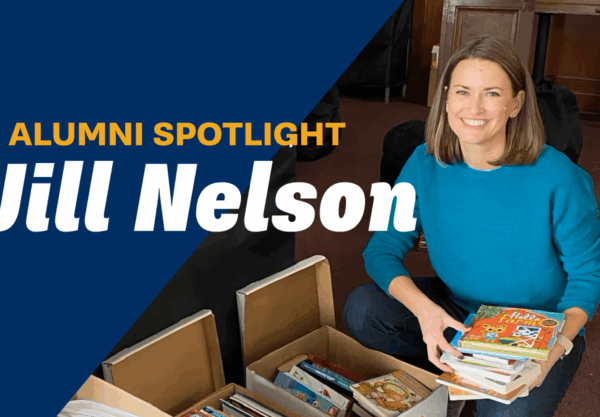 A woman smiling while holding a stack of childrens books, kneeling beside boxes of books. A banner reads, Alumni Spotlight Jill Nelson against a blue background.