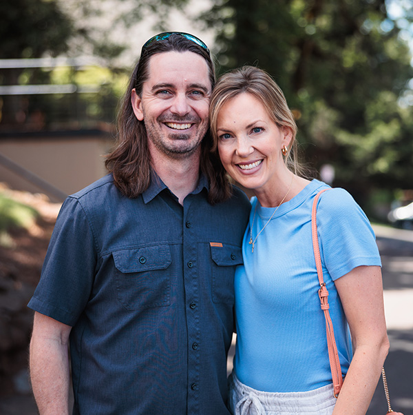 Alumni couple smile for the camera at their 20-year reunion event.
