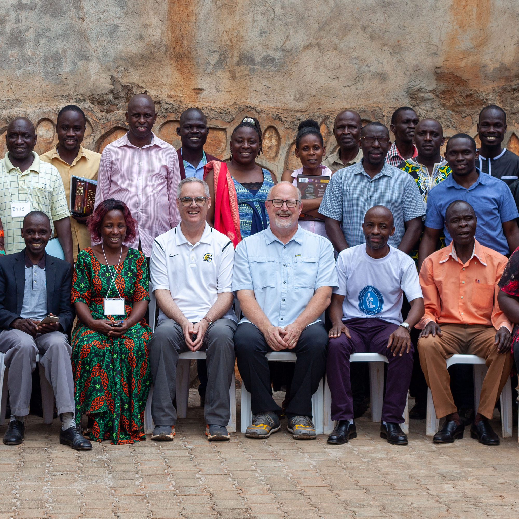A large group of pastors pose with their instructors during a training session in Uganda.