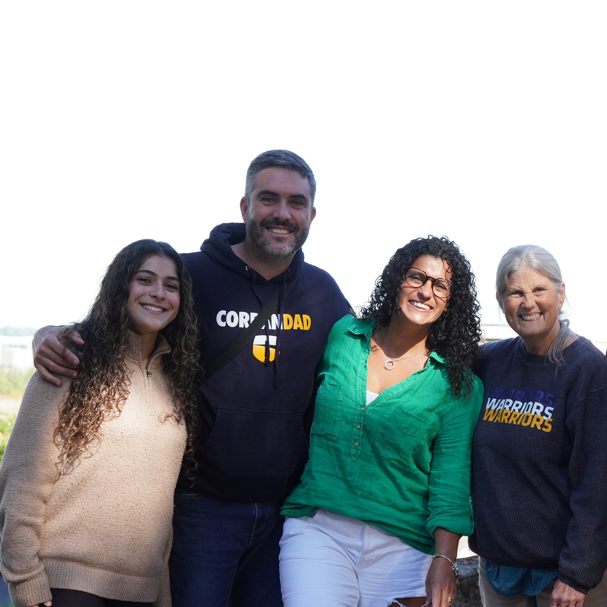 A student poses outside with her parents during Family Weekend.