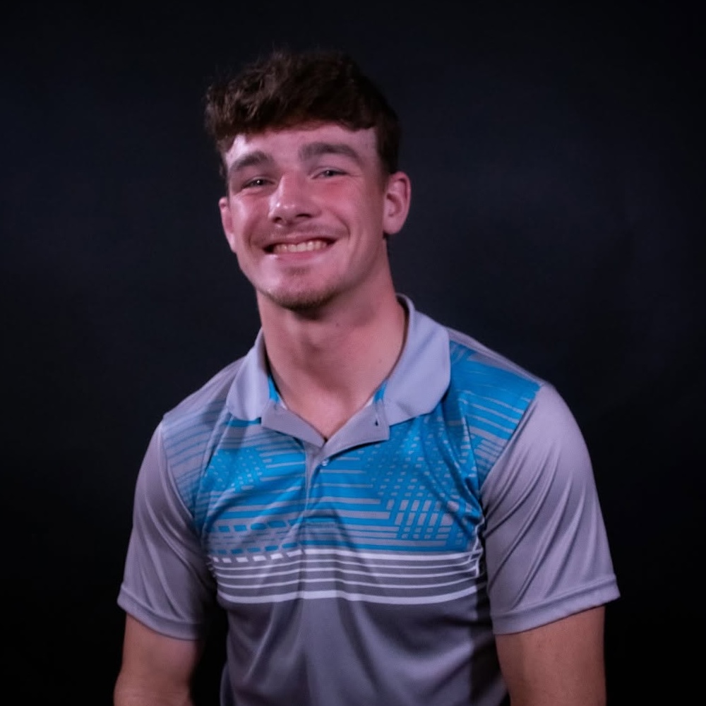 Portrait of Bo Davis, a young man dressed in a blue and gray polo shirt.