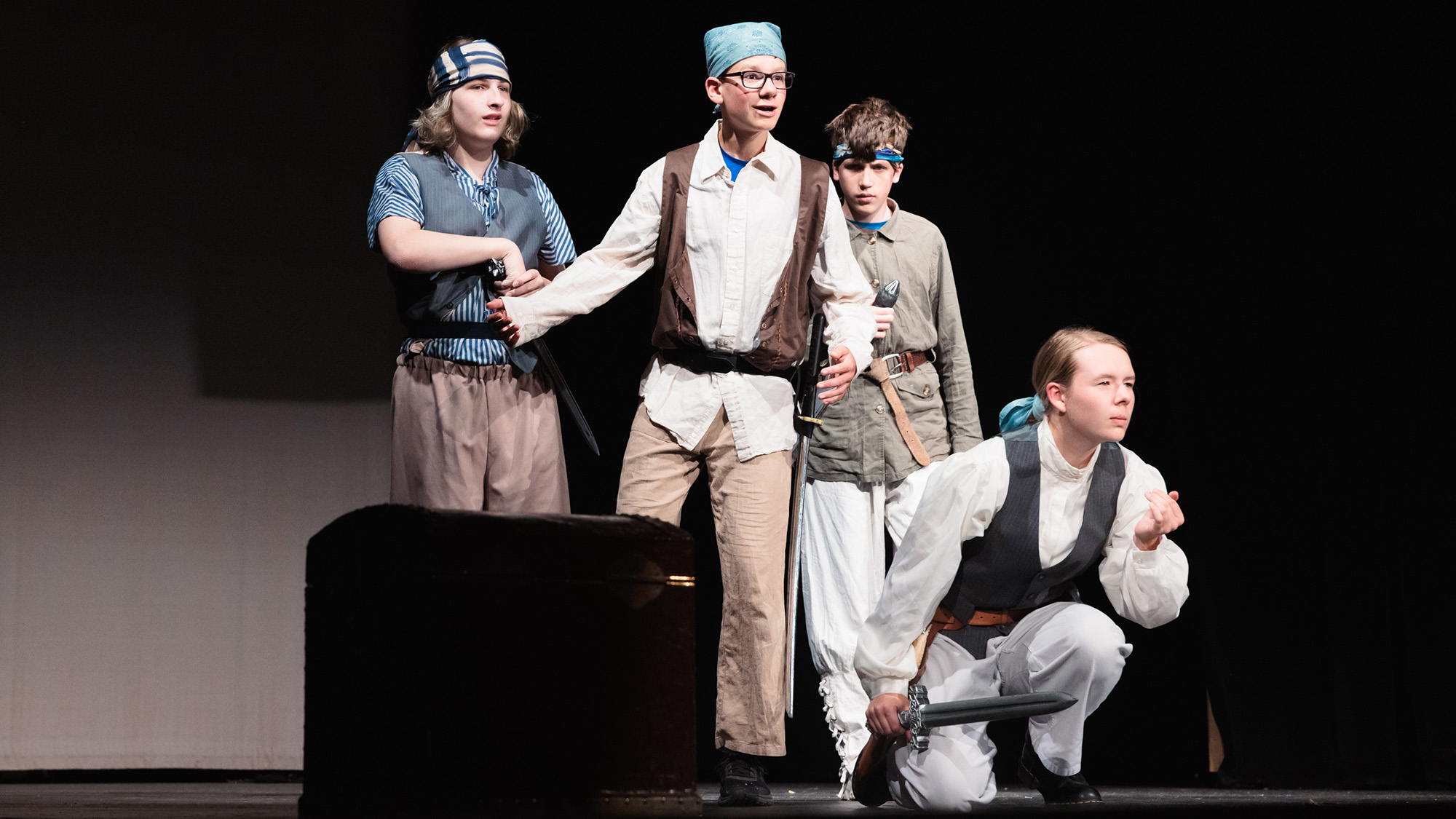 A group of young actors dressed as pirates perform on stage during Theatre Camp