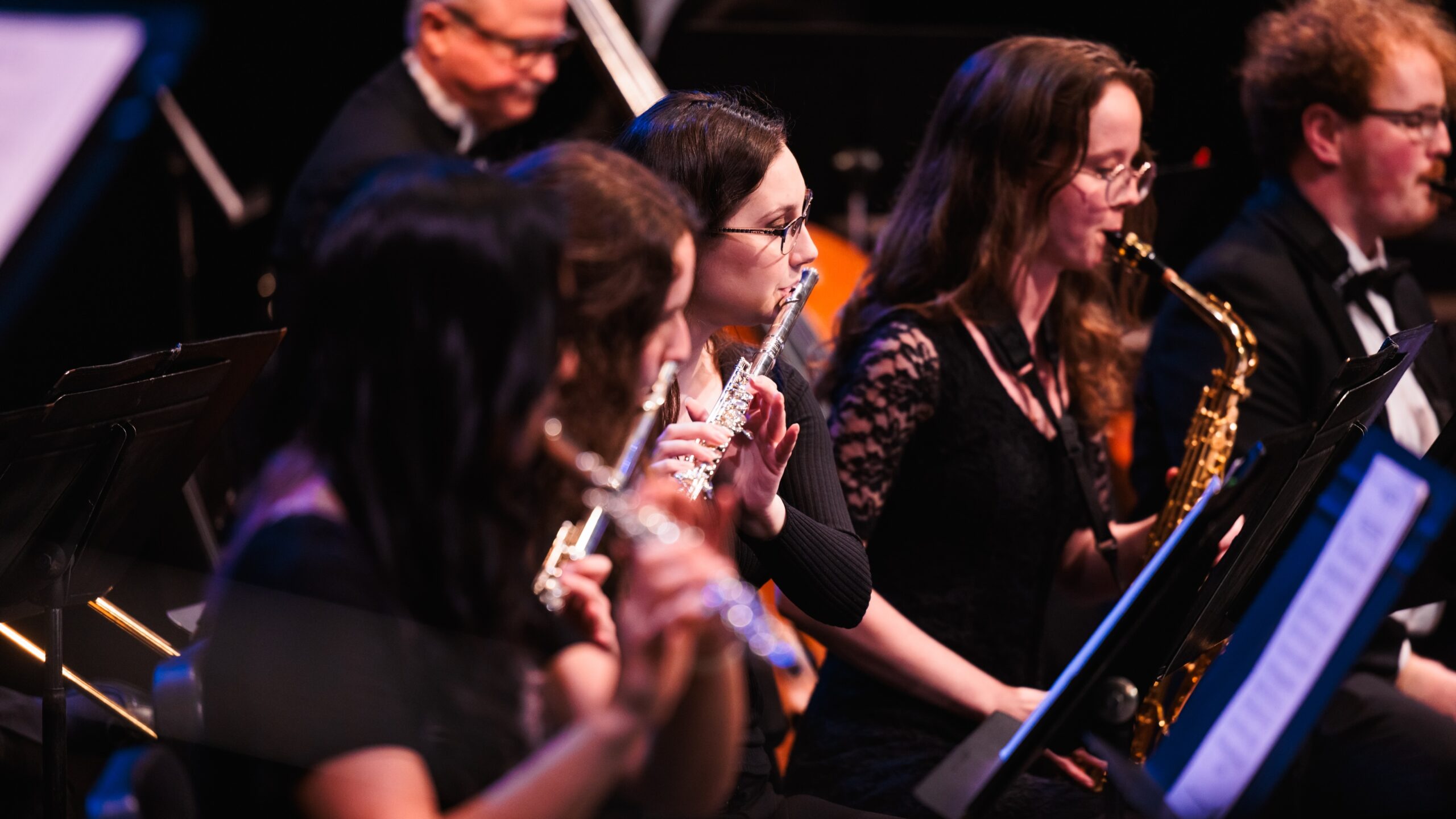 A group of musicians perform together at the Spring Showcase concert, showcasing their instruments and talent.
