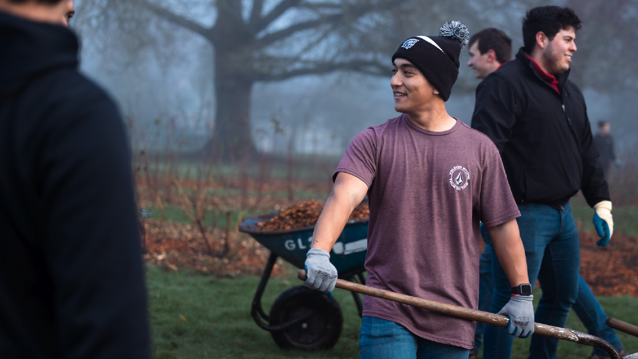 Students work in a outdoor setting, contributing to a community service project focused on environmental improvement.