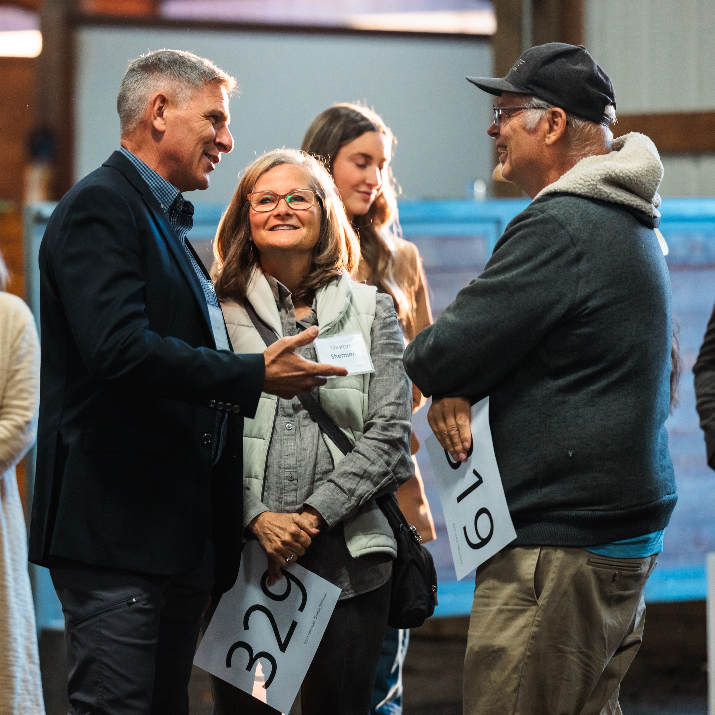 Two men and a woman converse at Corban's Ag Science Dinner.