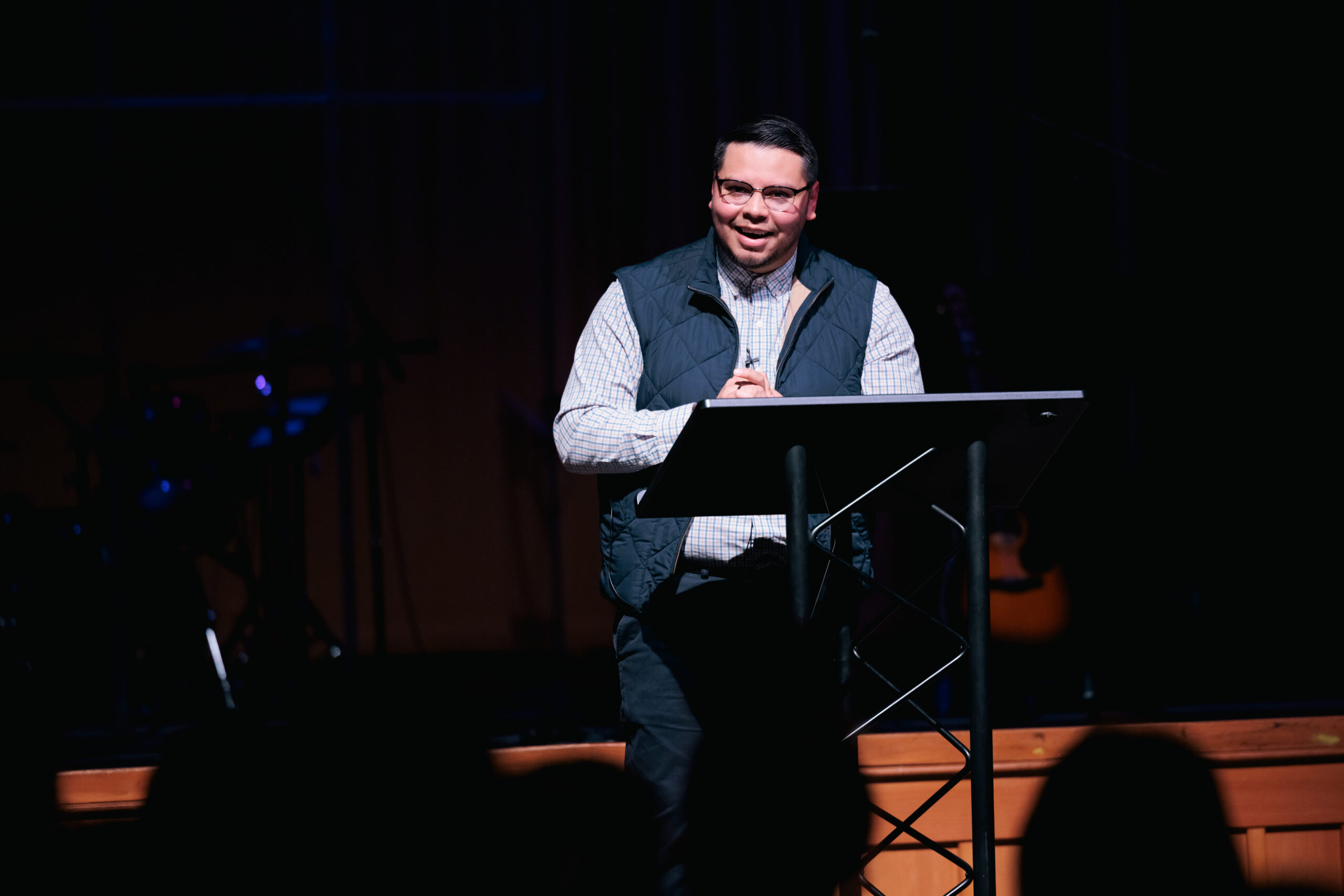 Sergio stands confidently at a podium, addressing an audience during chapel.