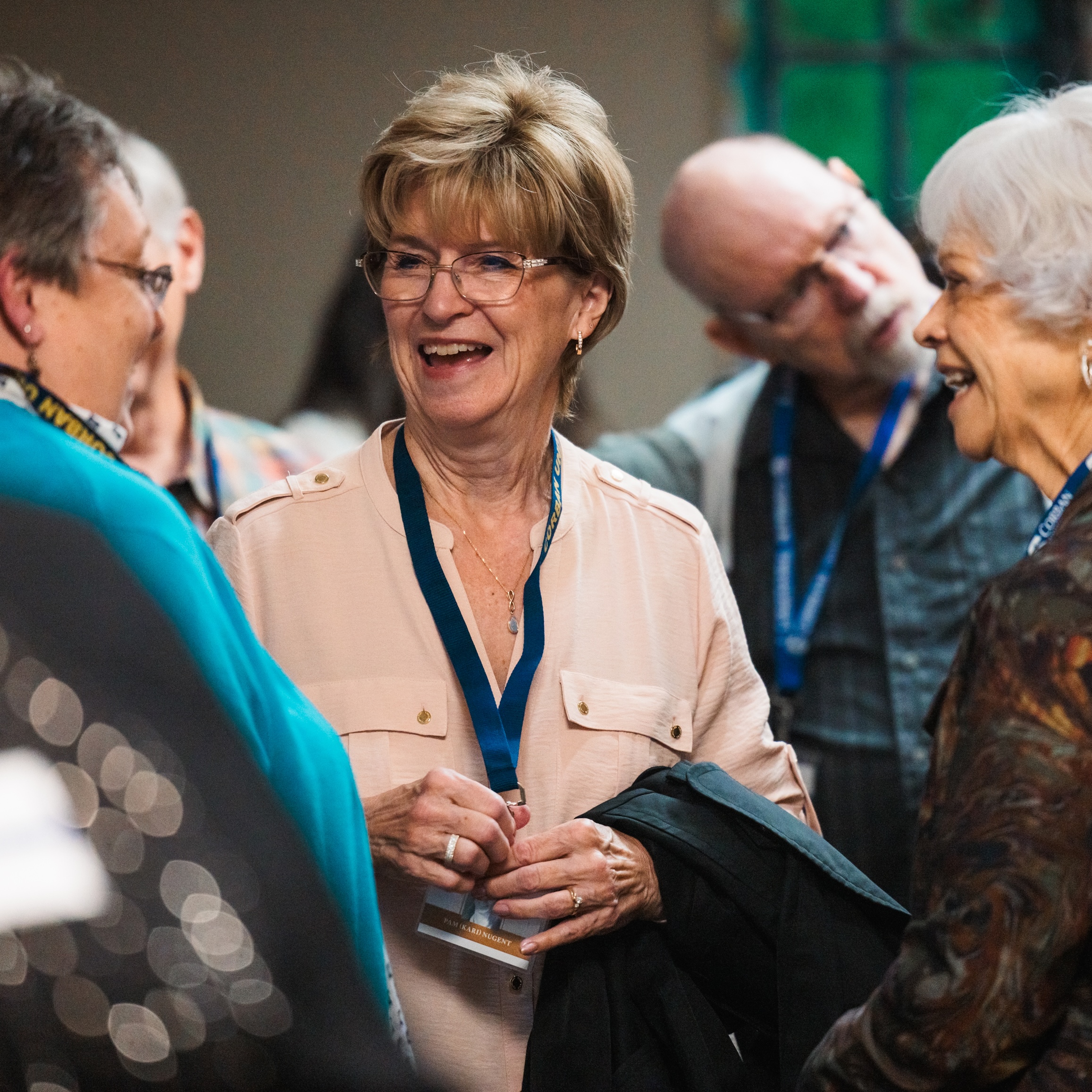 A woman participates in a conversation, displaying an attentive expression and friendly demeanor.