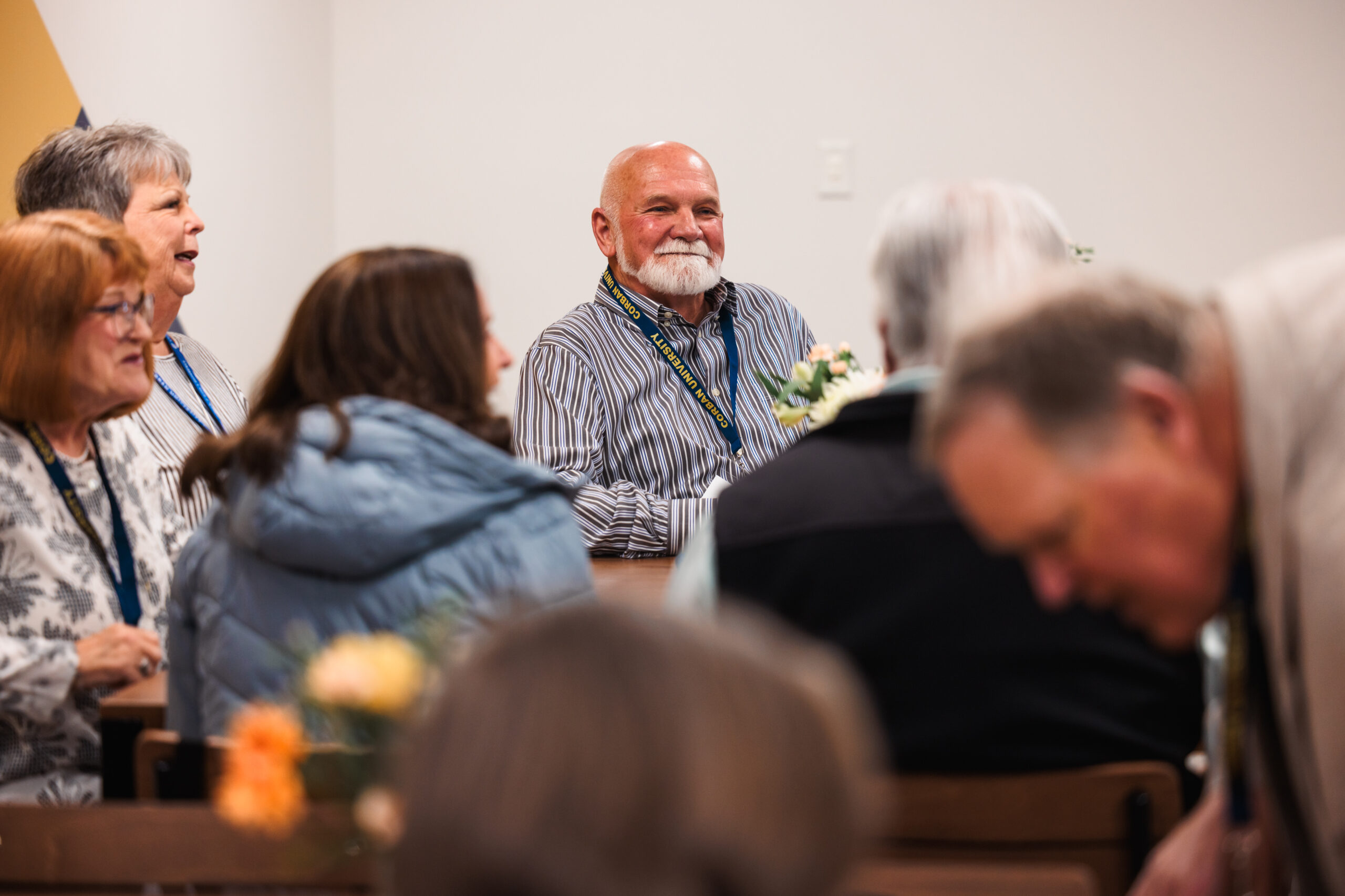 A group of people sitting at a table, participating in a collaborative discussion.