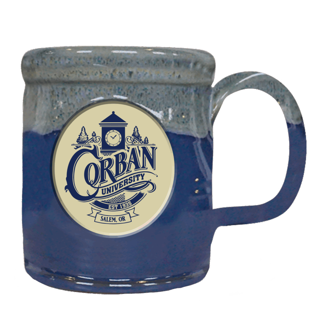 A blue and gray ceramic mug with the words "Corban University" printed on it with a clocktower design.