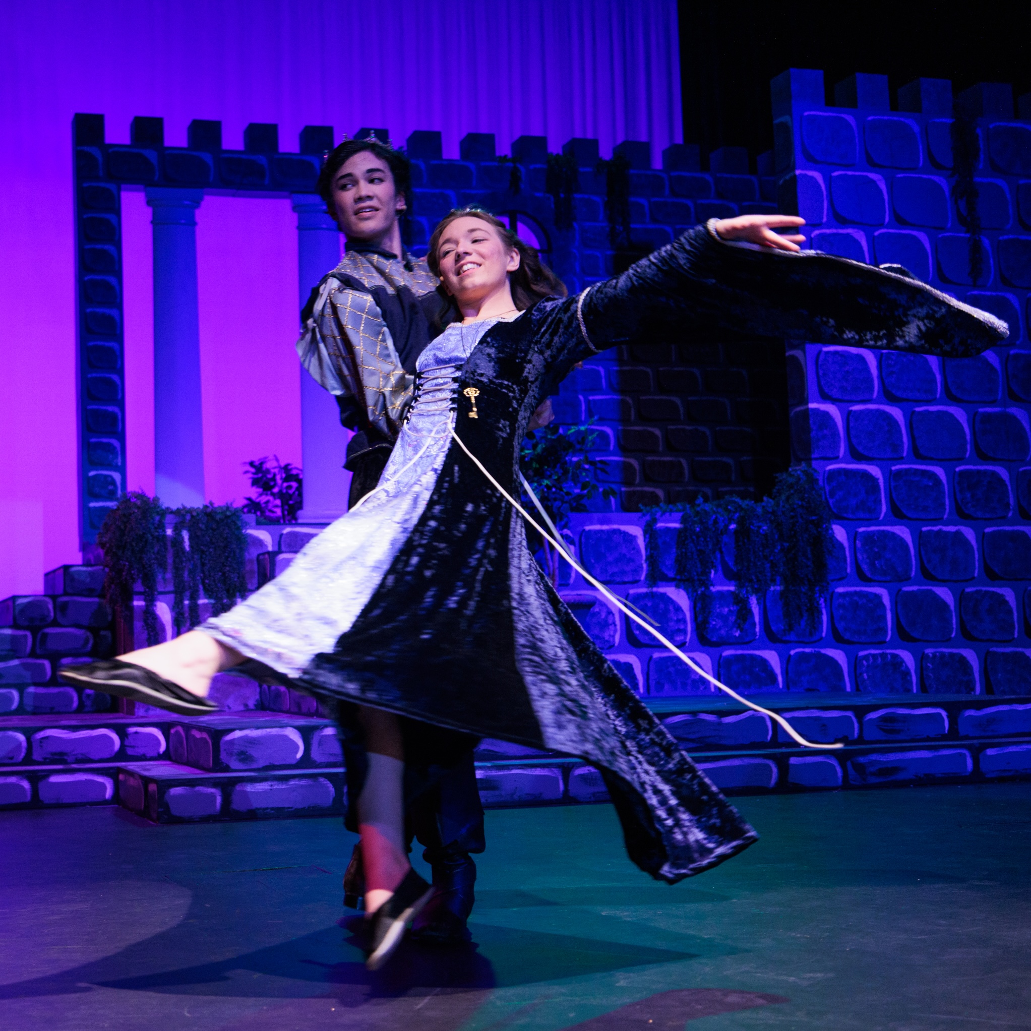 A couple dressed in medieval costumes and dancing, representing characters from the "Sleeping Beauty, Briar Rose" performance.