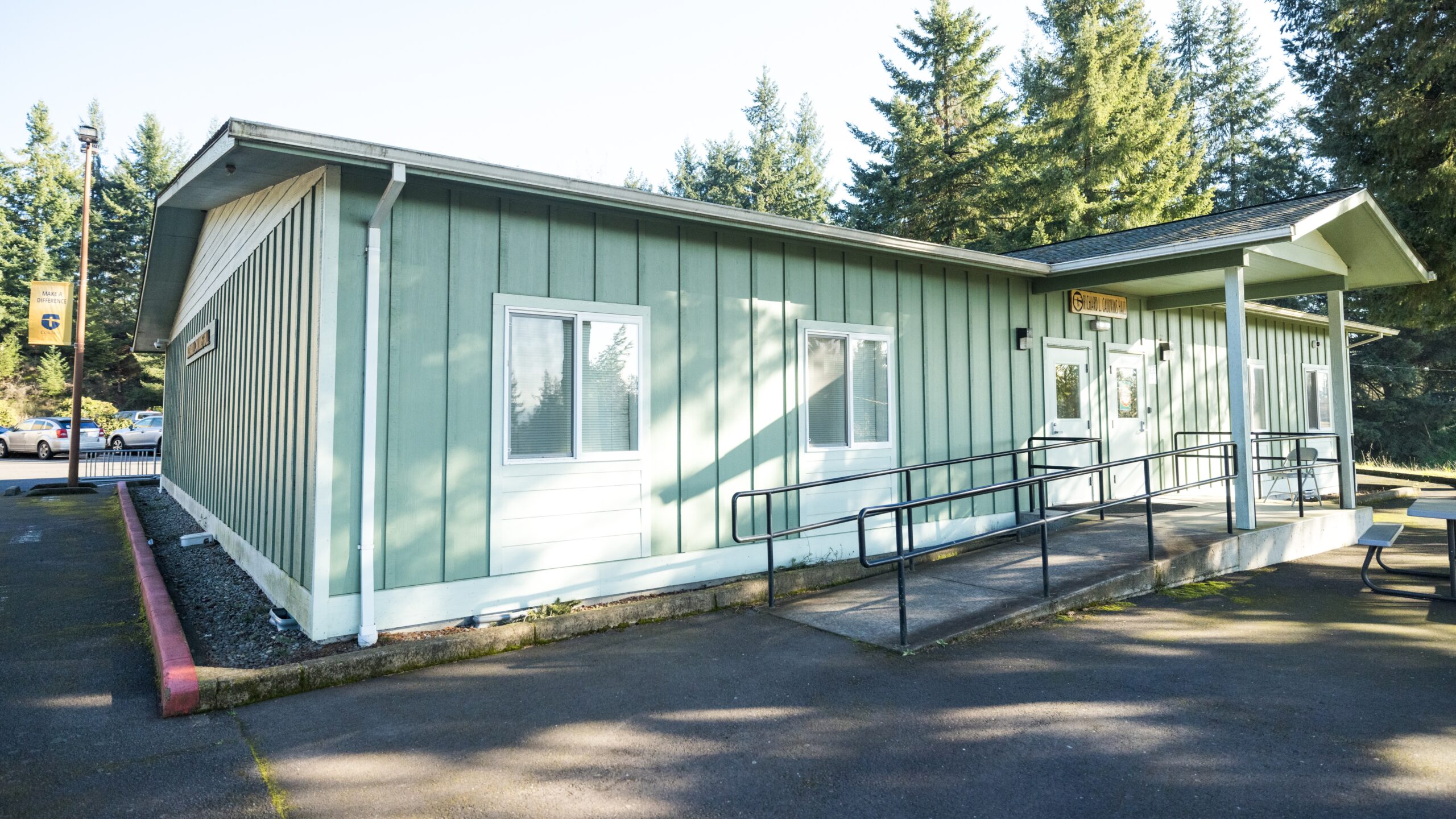 Caulkins Hall, a light green, single-story building.
