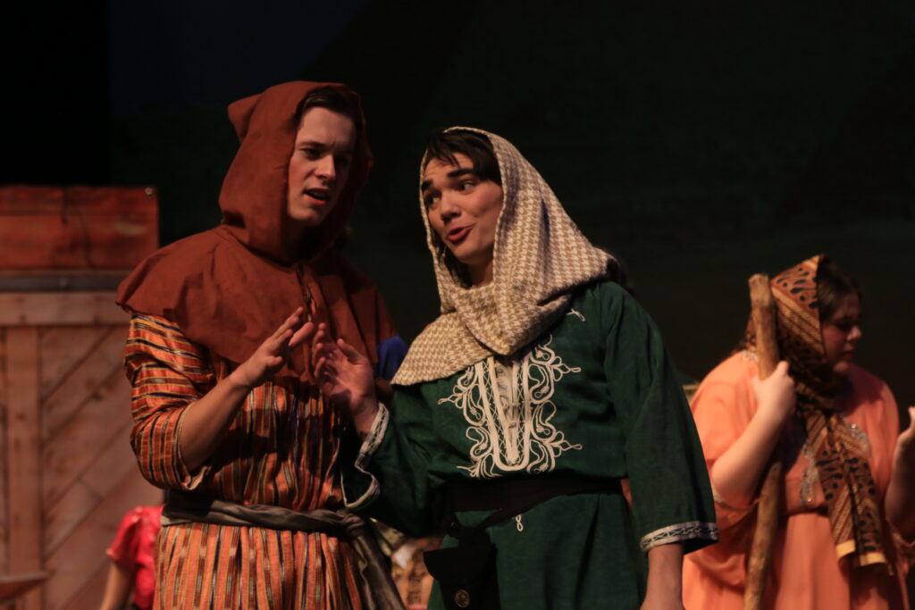 Two men in middle eastern clothing perform on stage during the play "Around the World in 80 Days."