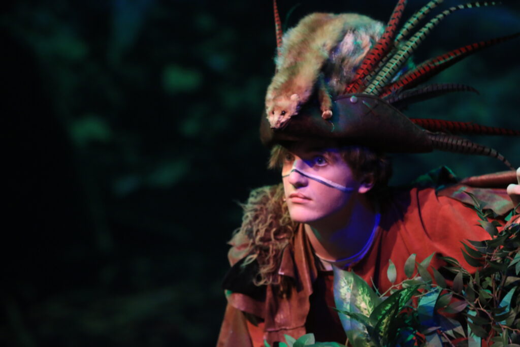 A man dressed in a vibrant tribal costume portrays a character in "Around the World in 80 Days."