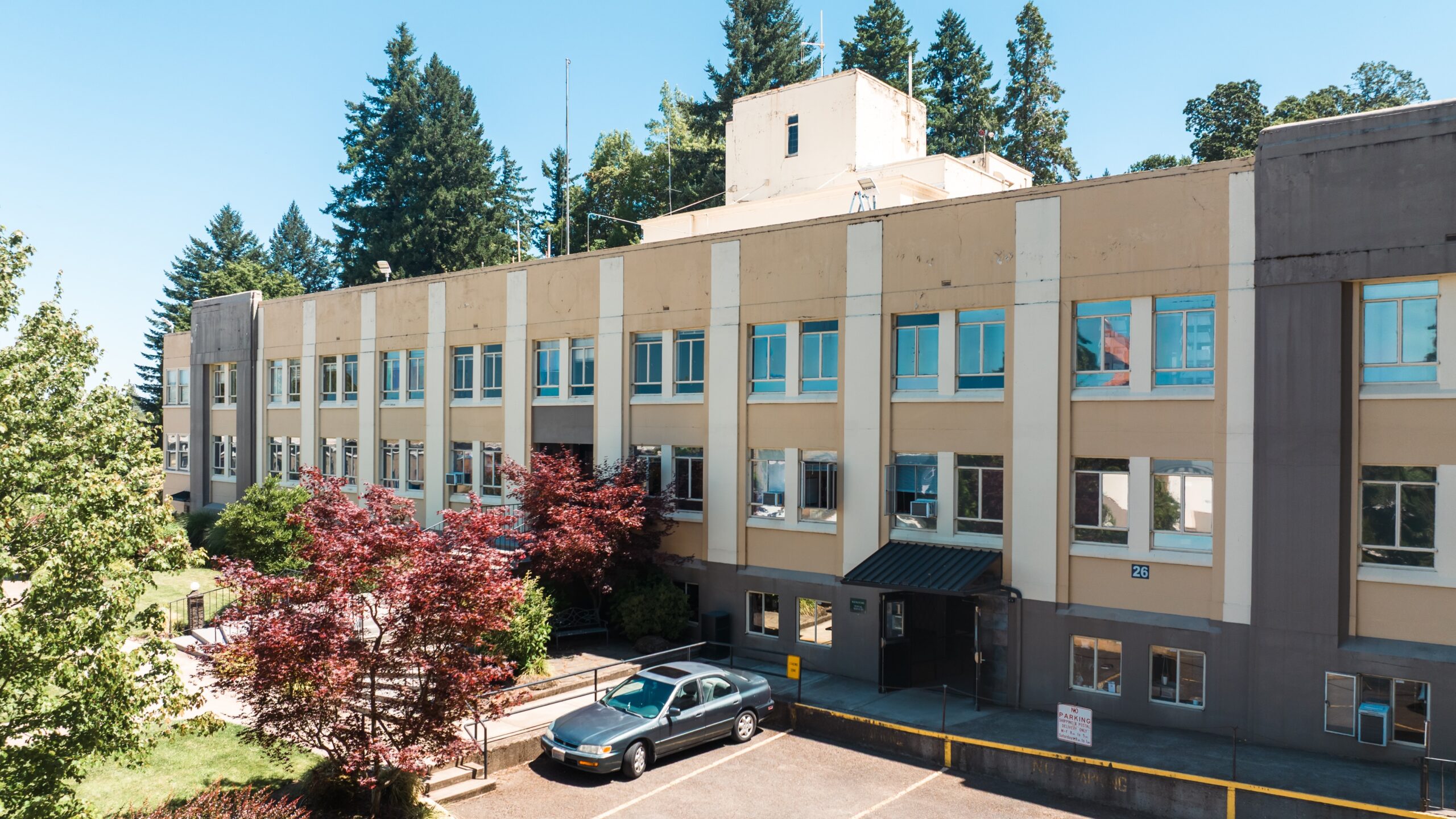 The front of the Academic Center with multiple floors and many windows on a sunny day.