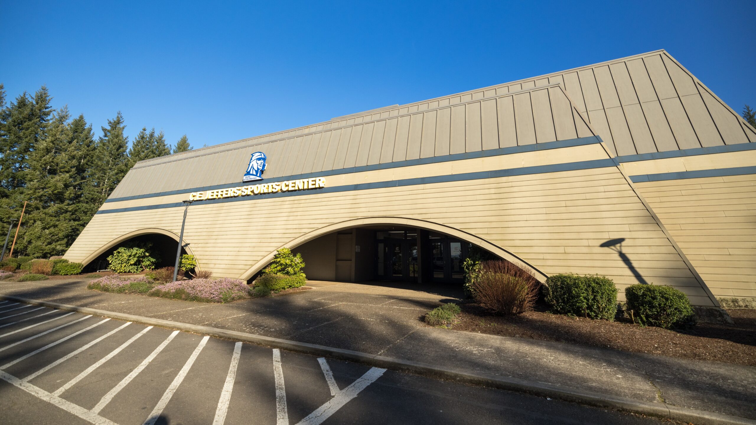 Front entrance of C. E. Jeffers Sports Center with a parking lot in front of it.